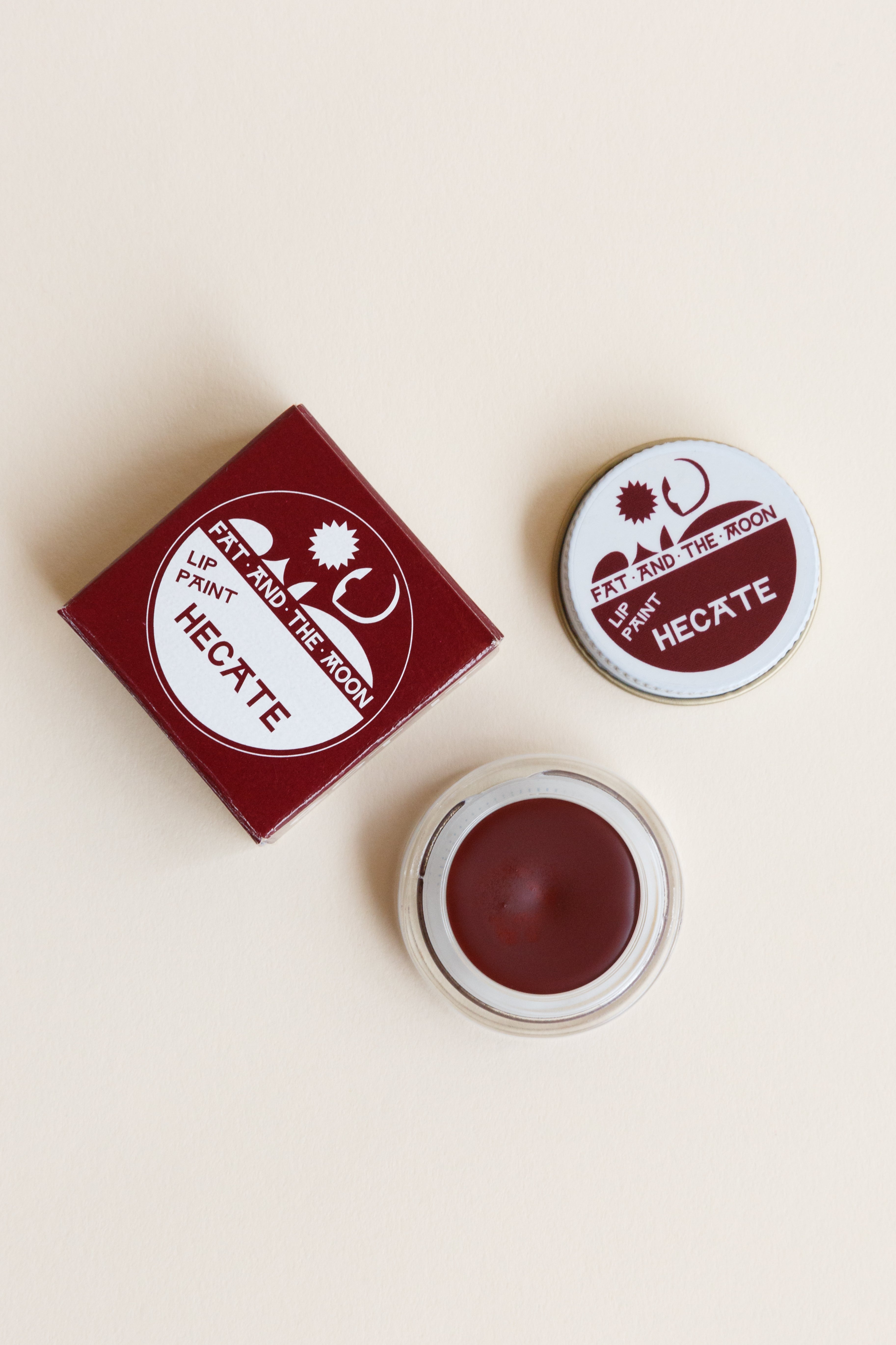 A jar of Fat and the Moon Lip Paint in Hecate color